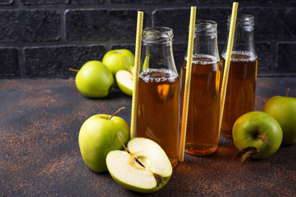 Bottles with fresh apple juice . selective focus