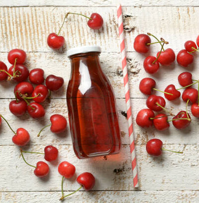 Cherry juice on the white table closeup