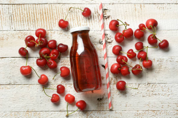 Cherry juice on the white table closeup